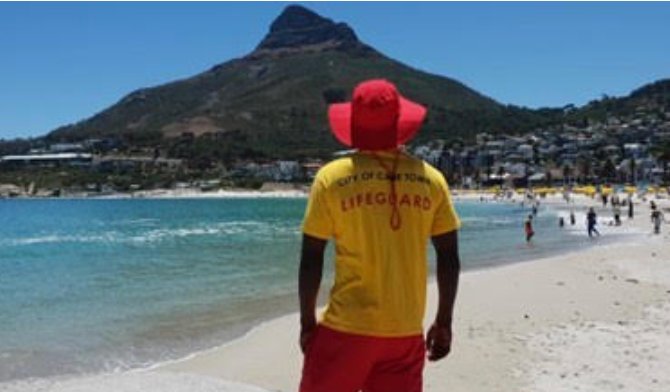 City of Cape Town lifeguard on the beach with Lions Head in the background