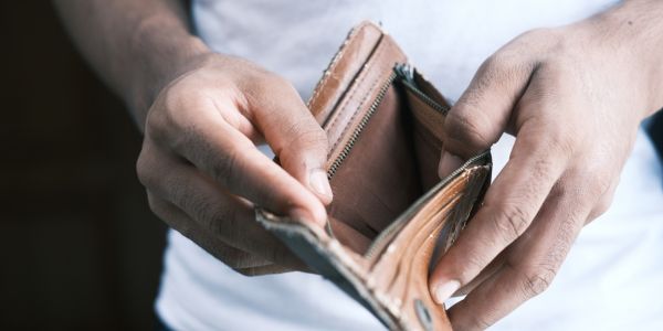 Empty wallet in worker's hands illustrating the South African cost-of-living crisis at the centre of the Cosatu Workers' Day 2026 rallies