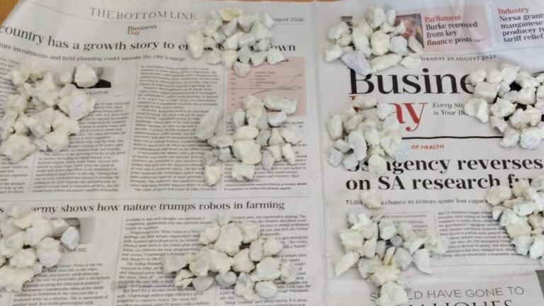 Stones suspected to be crack cocaine laid out and counted on newspaper after a seizure at Bram Fischer International Airport
