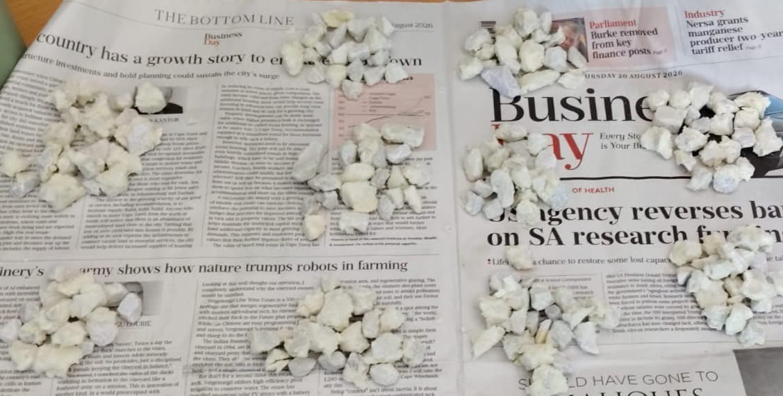 Stones suspected to be crack cocaine laid out and counted on newspaper after a seizure at Bram Fischer International Airport