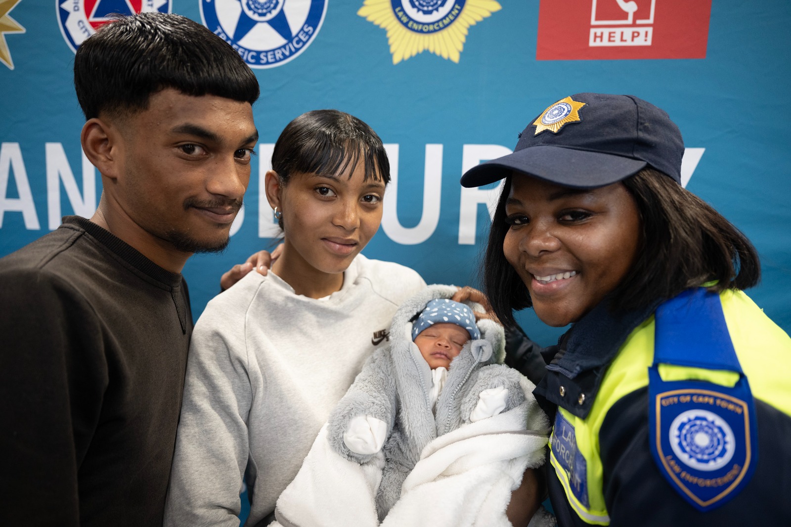 Kaylee Luyt and Yazeer Losper with baby Mahier and Cape Town Law Enforcement officer Zibula Sitemele