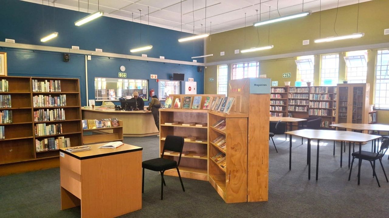 Interior of a City of Cape Town public library with bookshelves and reading tables