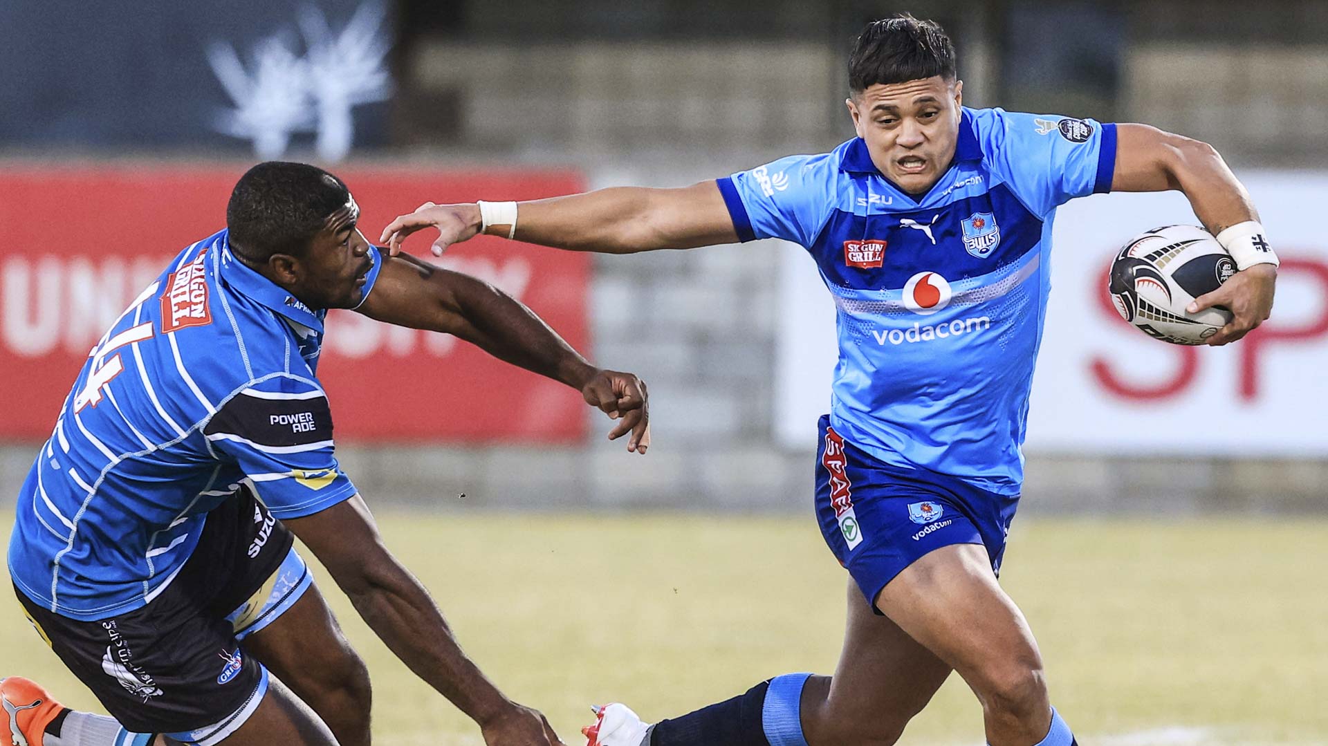 Vodacom Bulls XV player fends off a Suzuki Griquas defender during a Carling Currie Cup match
