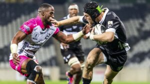 Hollywoodbets Sharks XV player fends off an Airlink Pumas defender during a Carling Currie Cup match