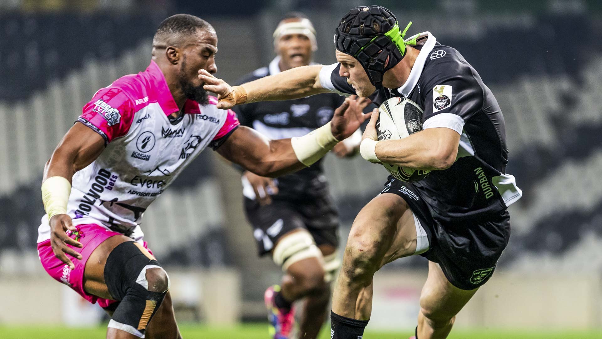 Hollywoodbets Sharks XV player fends off an Airlink Pumas defender during a Carling Currie Cup match